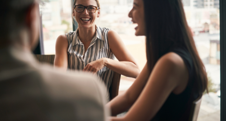 3 people chatting in an office
