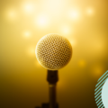 Microphone against goldish background to represent efficient tone of voice