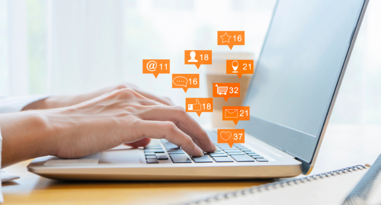a laptop with lots of icons depicting alerts, likes and conversations