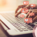 Person typing on laptop with social icons suggesting likes and engagement. Image is symbolic of multiple marketing techniques on offer.